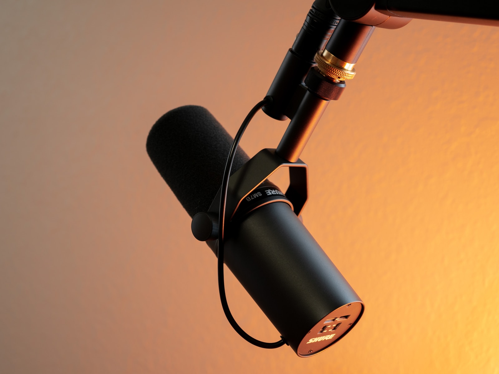 black and silver microphone on brown wall