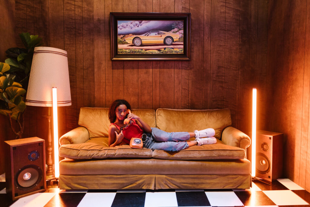 A woman lying on the couch while on the telephone