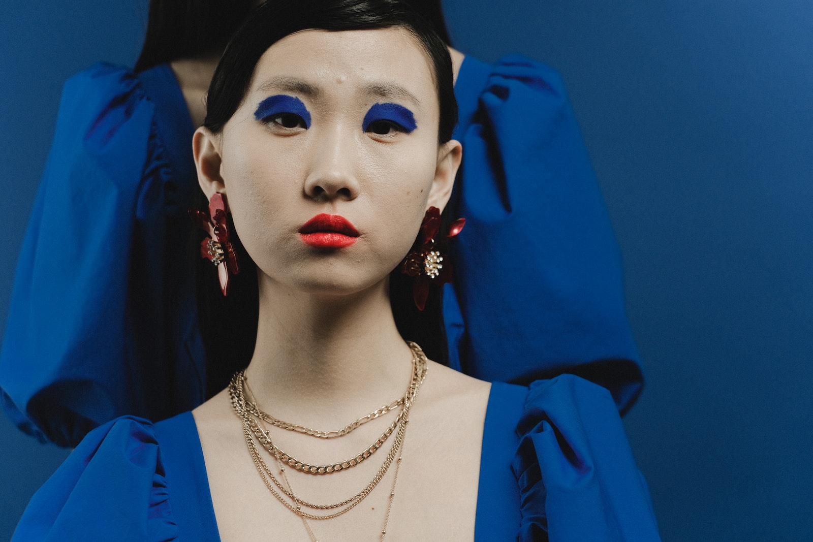 Woman in Blue Blazer Wearing Gold Necklace