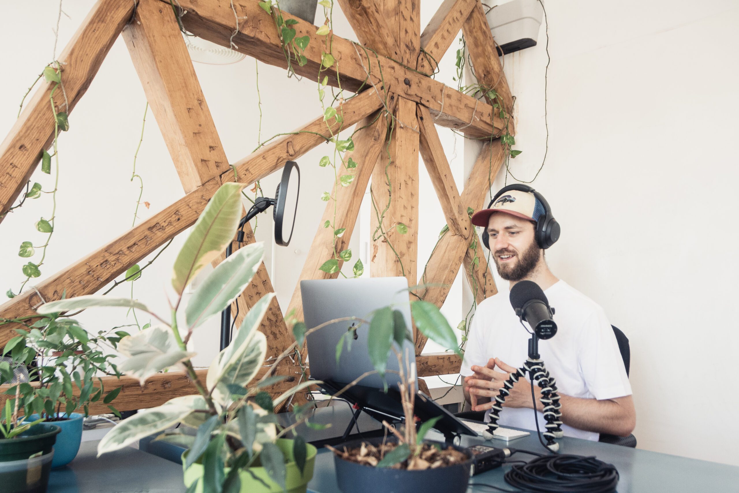 A man in white shirt doing audio podcast