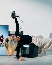 Photo of Woman Leaning on Top of Television